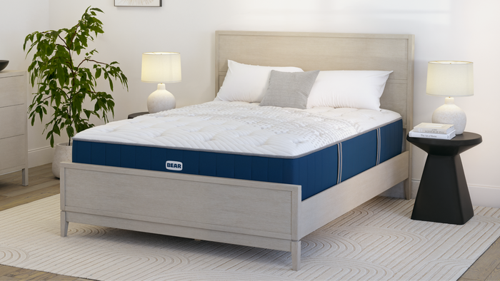 Bear mattress on wood bed frame with headboard and footboard